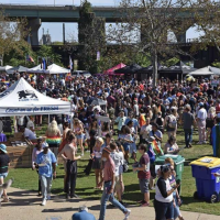Crowd of Oktoberfest participants visiting local business booths and presentations